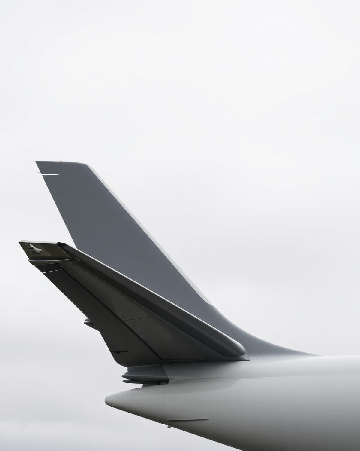 Aircraft winglet with a clean glossy finish against an overcast sky